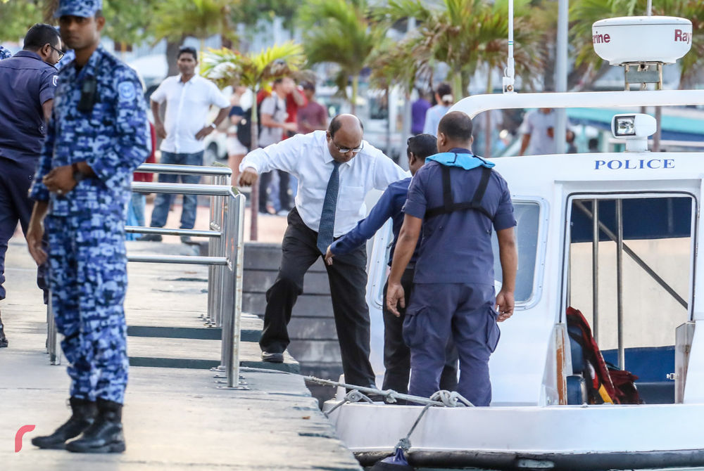 Detained Chief Justice Abdulla Saeed alights a speed boat on which he was transferred from his holding cell to capital city Malé for an earlier remand hearing