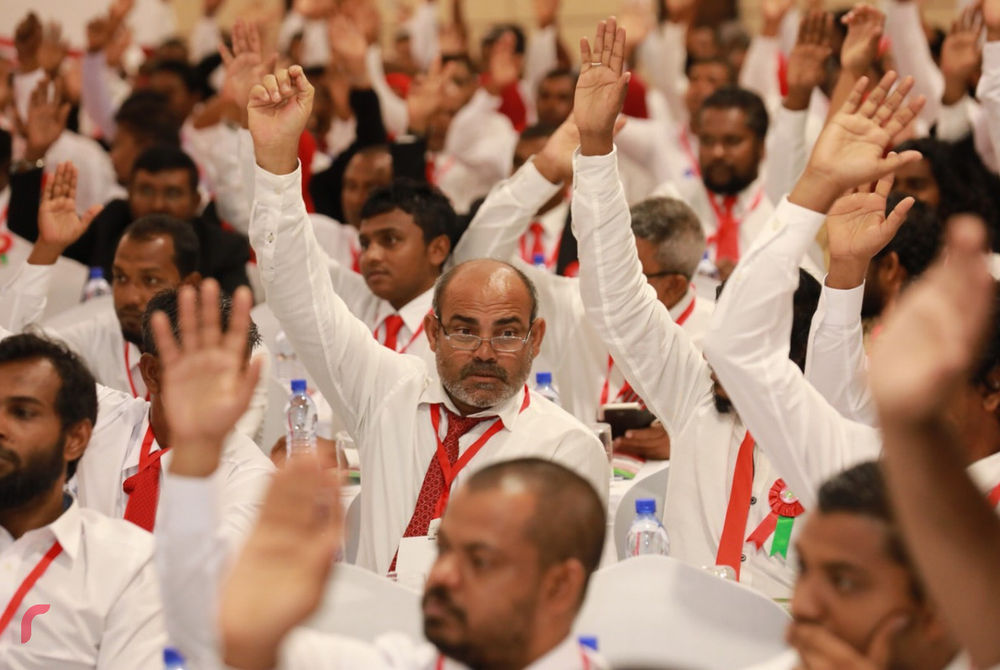 Jumhooree Party members take a vote at the party congress