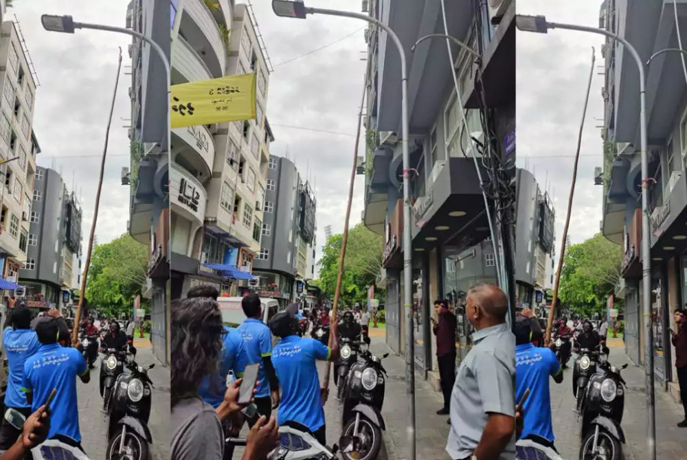 City council workers take down banners put up for the massive MDP demonstration scheduled for October 3.