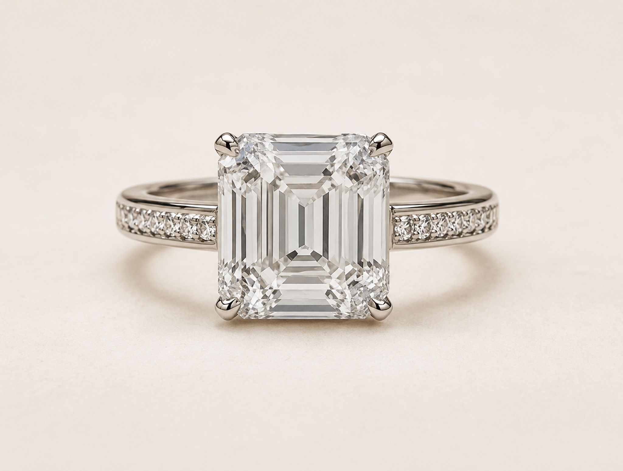 An emerald-cut three-stone ring with hand-set side diamonds