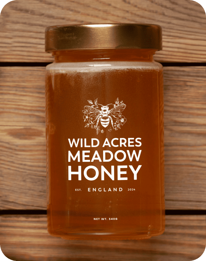A clear jar of Wild Acres Meadow Honey against a wooden backdrop