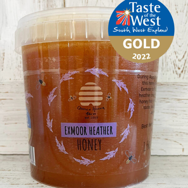 A clear plastic 1.5kg tub of Scottish Heather Honey from Quince Honey Farm with a Taste of the West South West Gold award logo for 2022