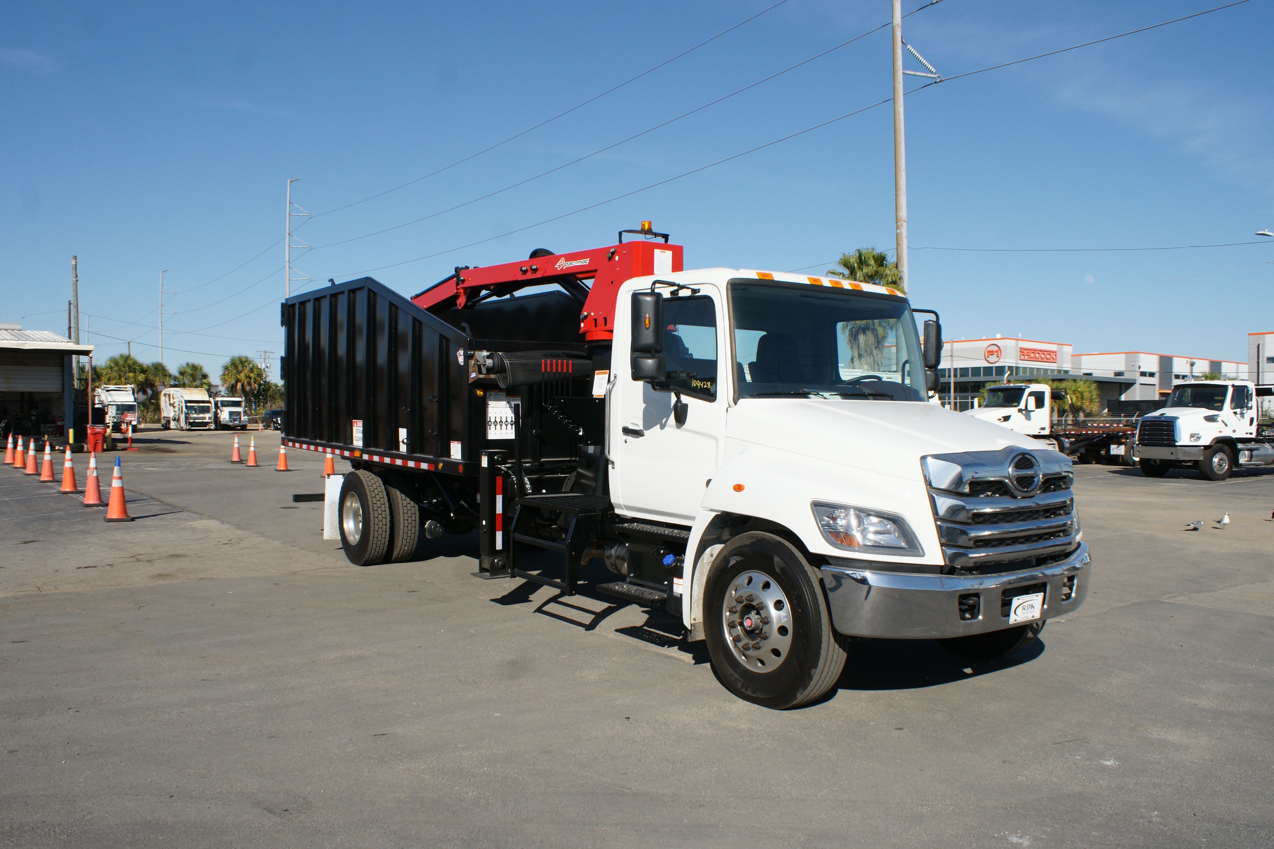 2025 Hino L7 grapple truck with 28-yard Pac-Mac KB20 body