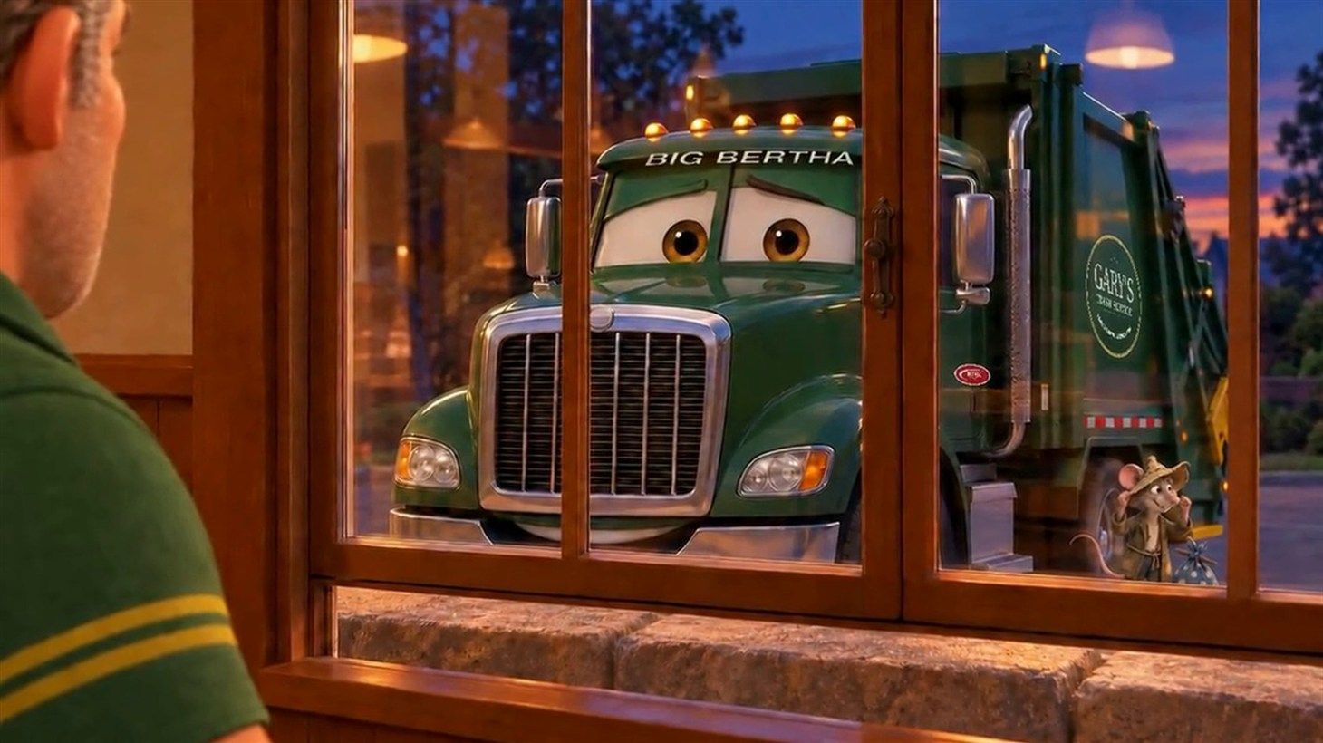 Through the church hall window at dusk, Big Bertha the green rear loader with expressive eyes and a Gary's Trash Service door badge raises one eyebrow while Gary's shoulder is visible in the foreground