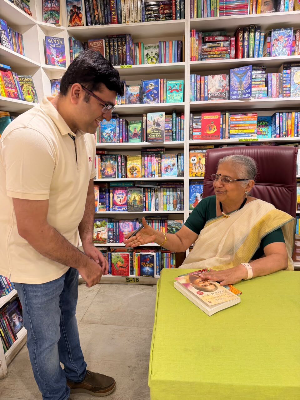 Sudha Murty signing a book with Somil Makhija at KoolSkool, Gurugram
