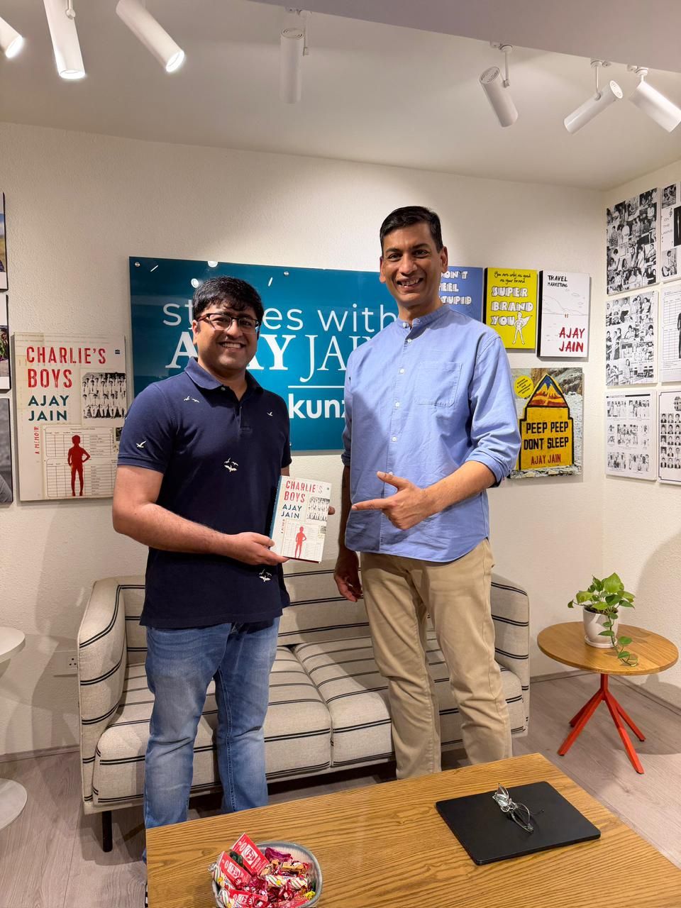 Kunzum founder Ajay Jain with Somil Makhija holding a copy of Charlie's Boys at Kunzum, GK