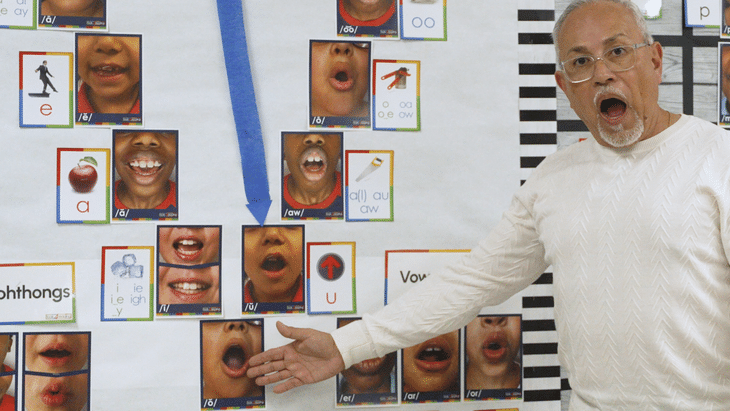 Antonio Fierro in front of a board showing the Vowel Valley