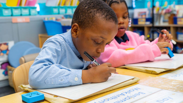 Boy writing at his desk