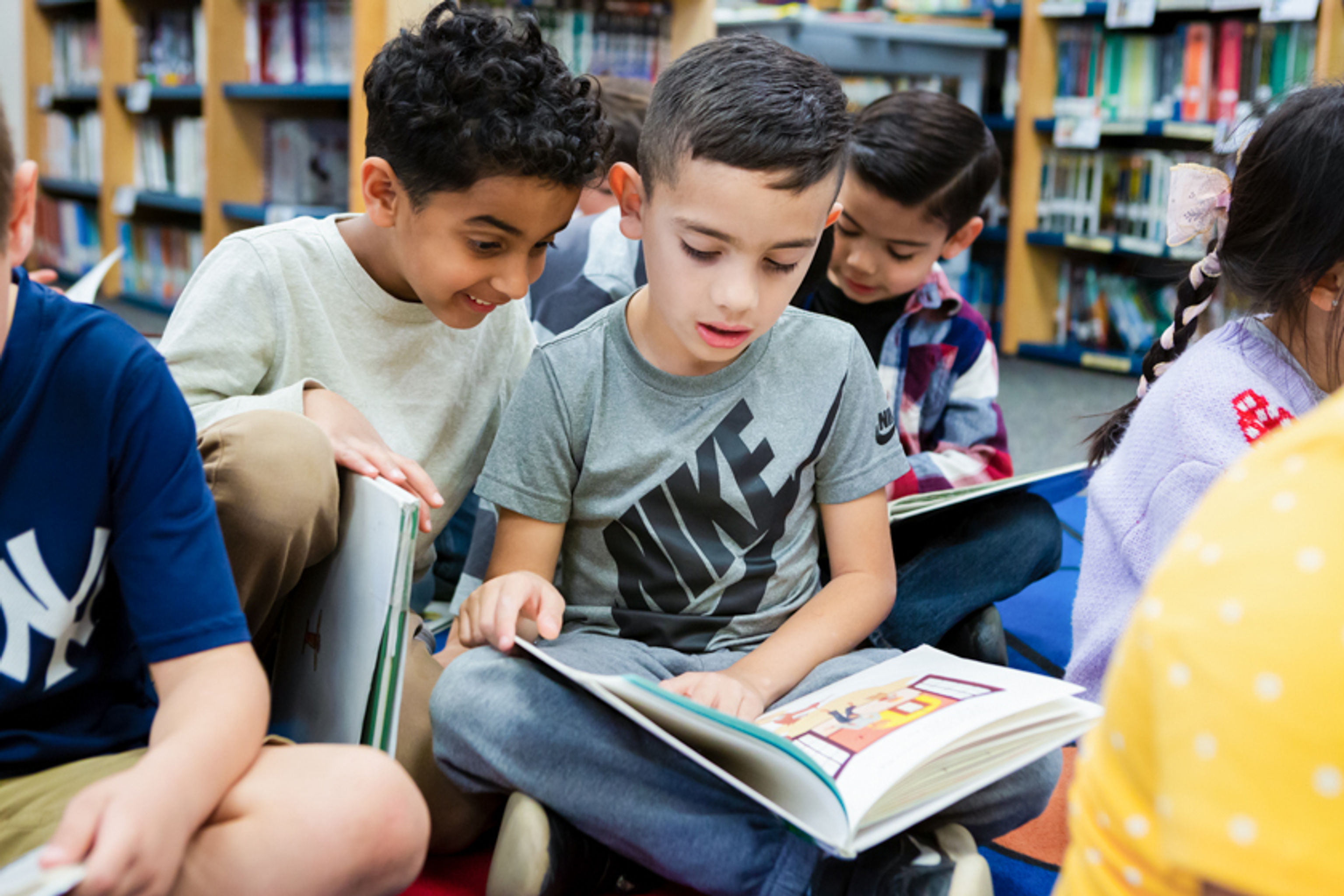 Two boys reading together