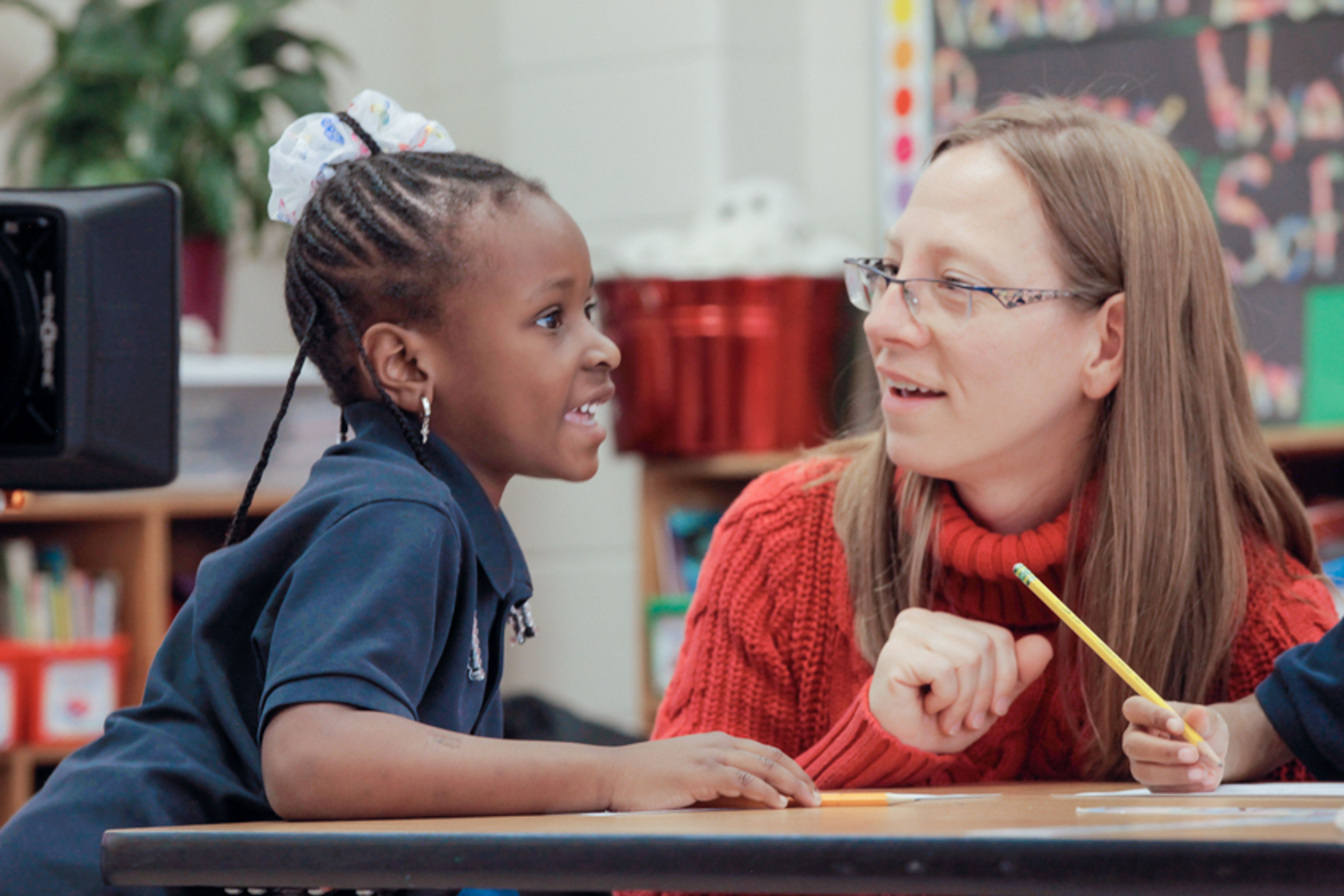 Teacher and student talking at a table