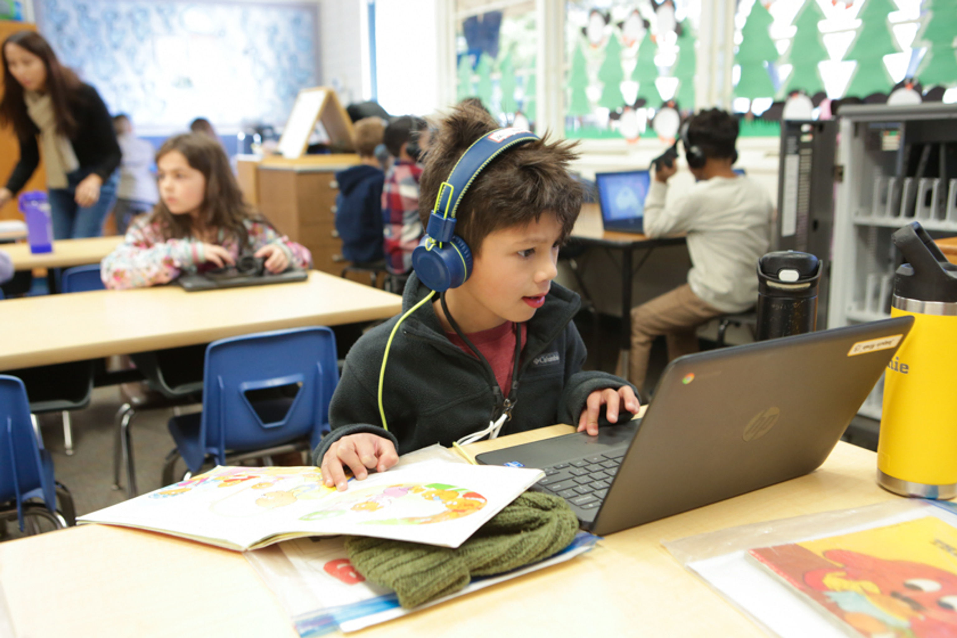 Student wearing headphones doing comprehension activity on laptop