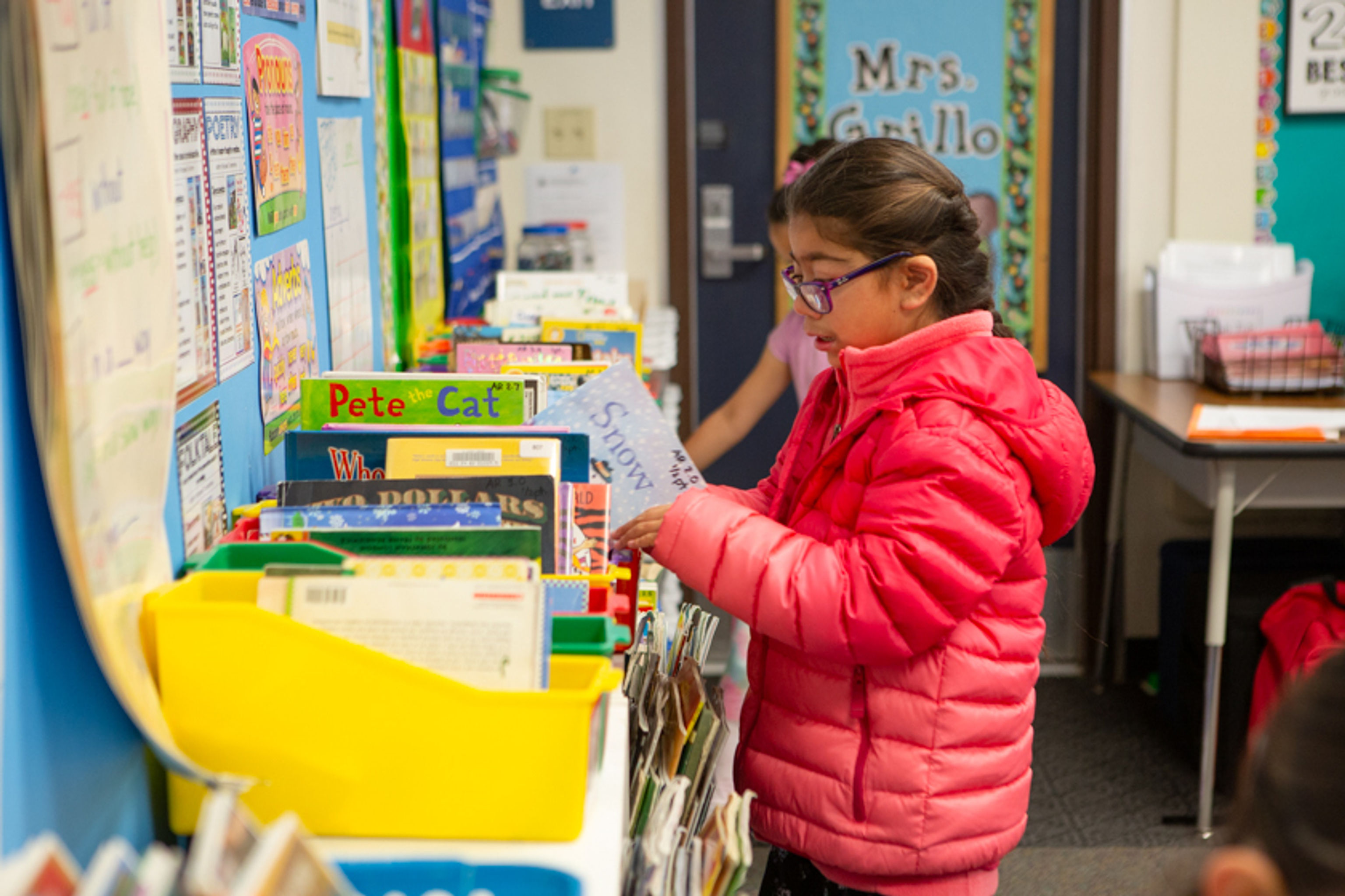 Student selecting a book to read