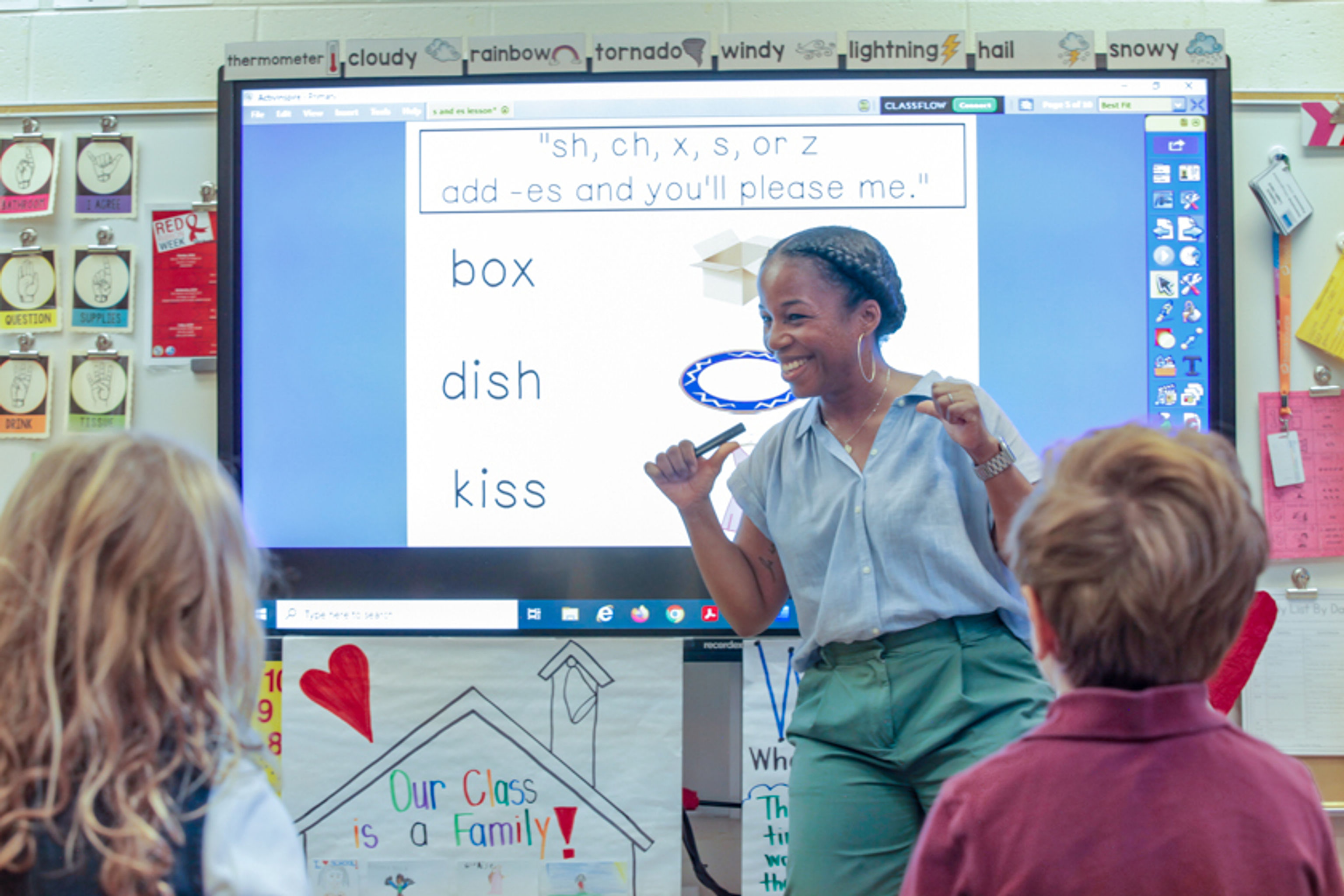 Teacher works on phonics with first graders using a smart board