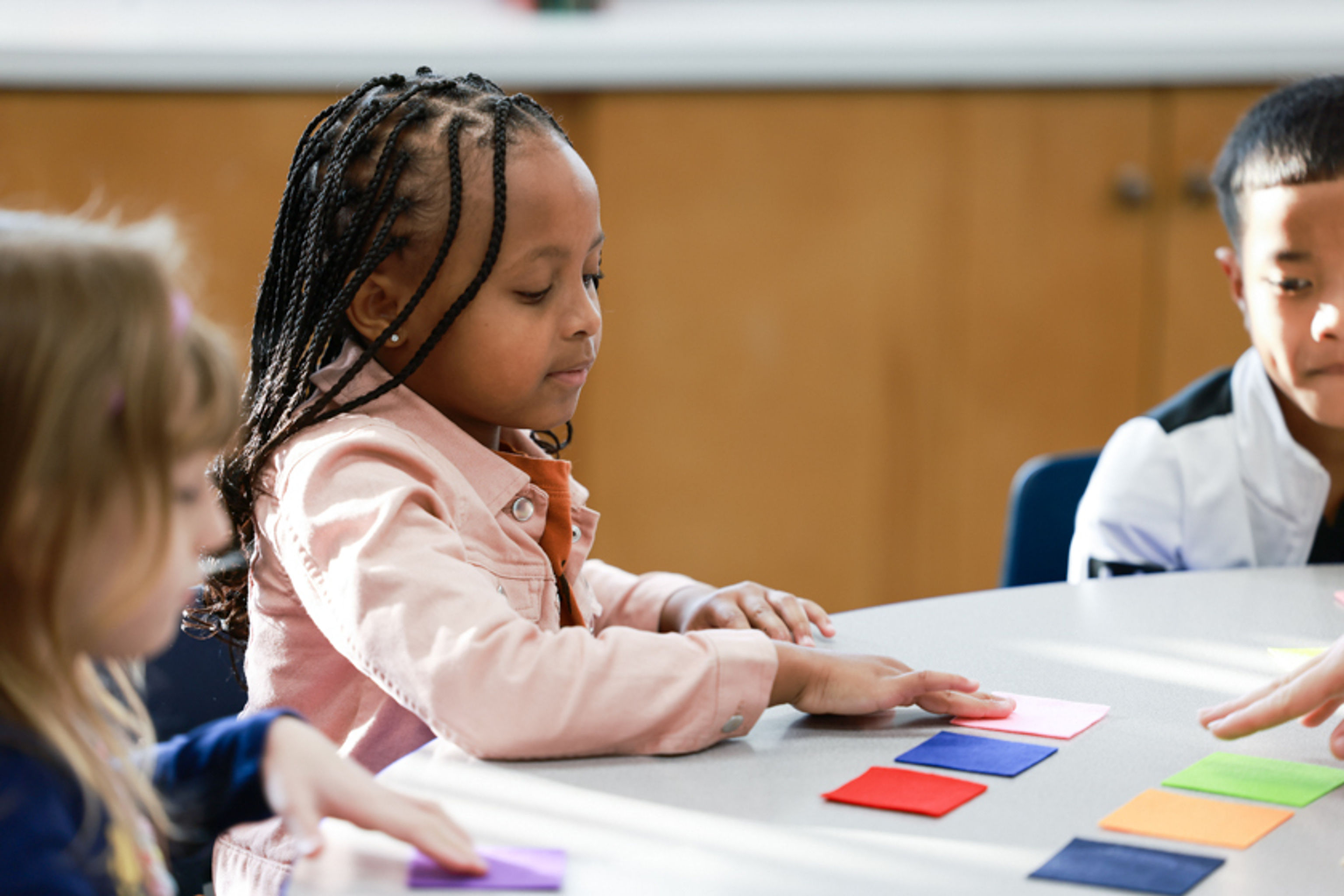 Student manipulates felt squares