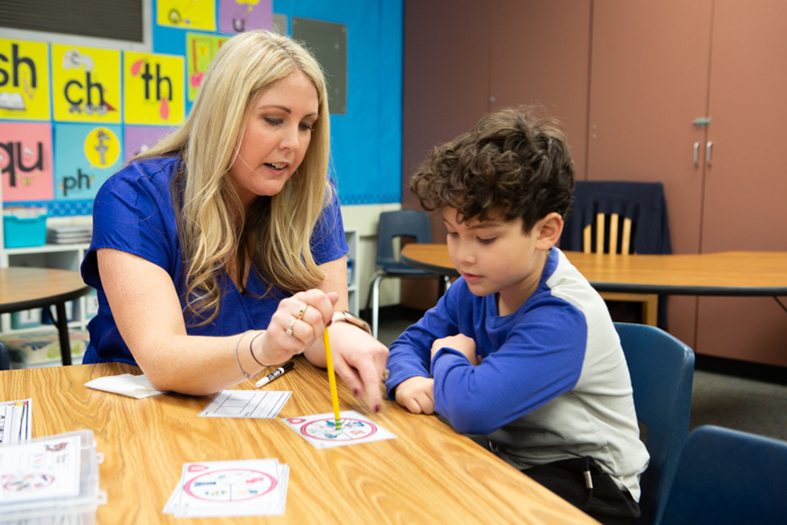 Student and teacher practice together with flash cards