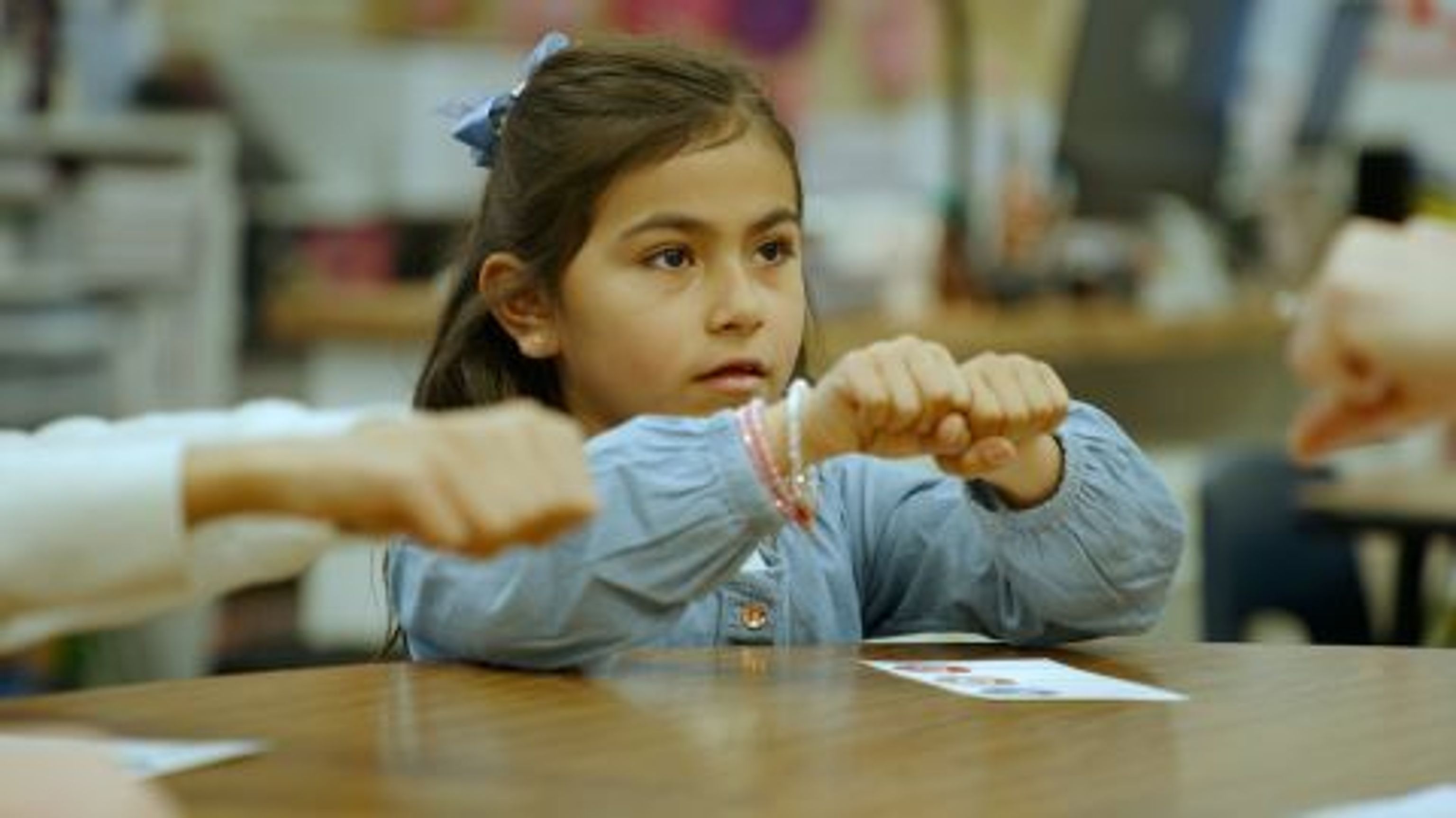 First grader holding her fists together