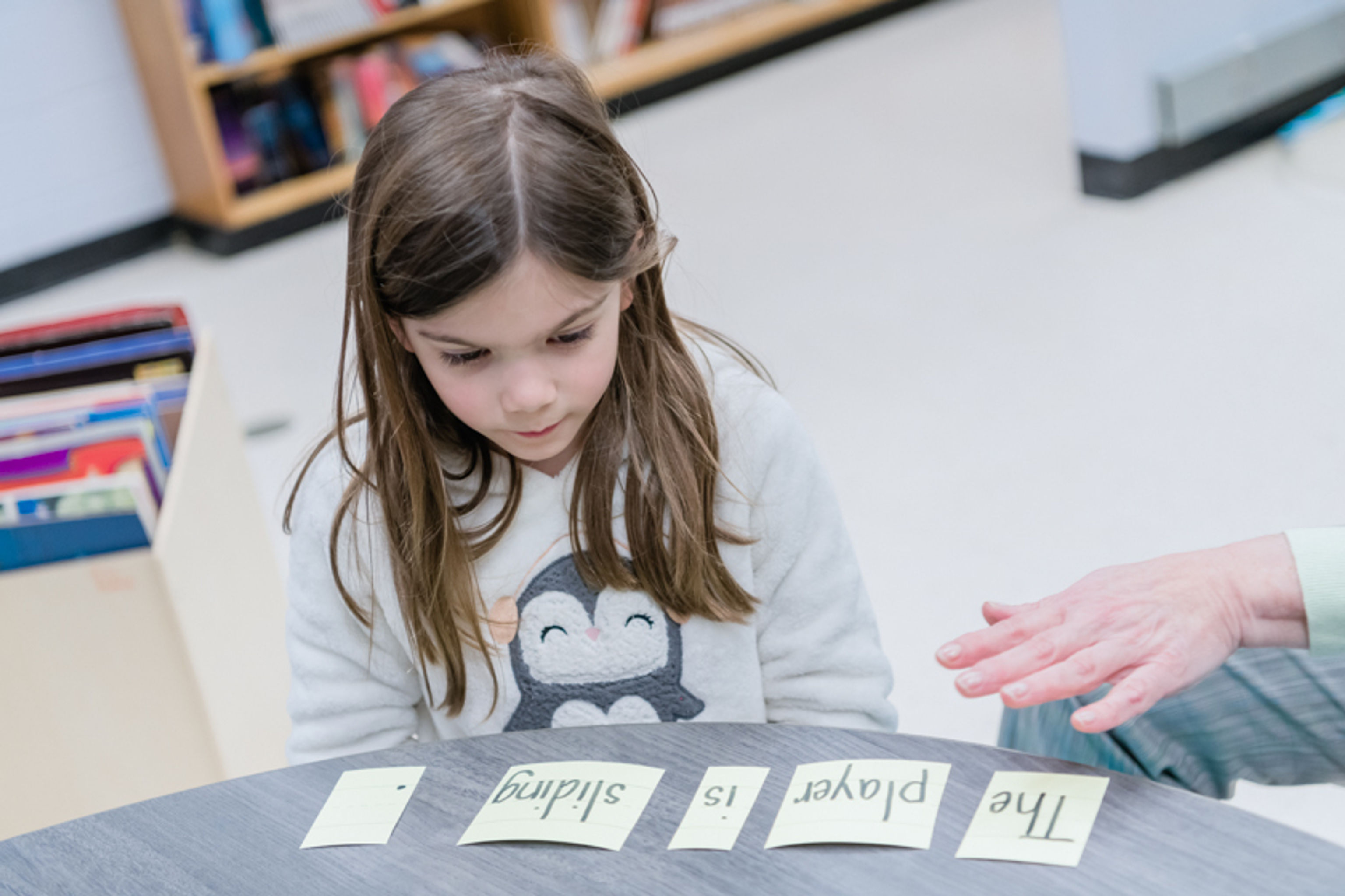 Student constructs sentences using cards