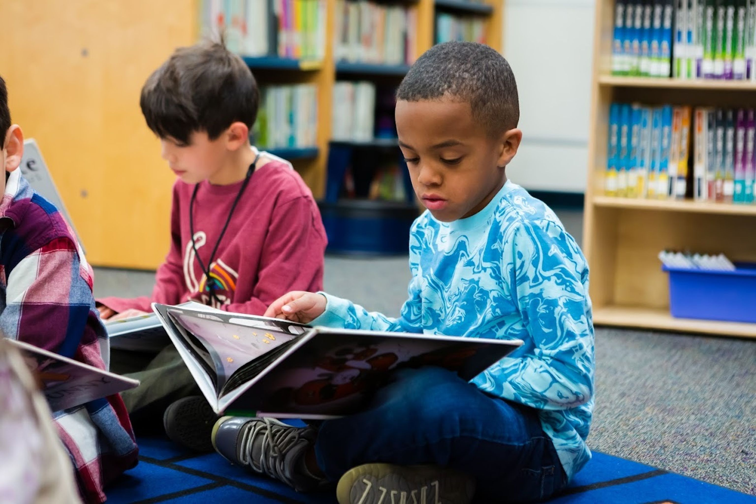 Kids reading on the floor of the library