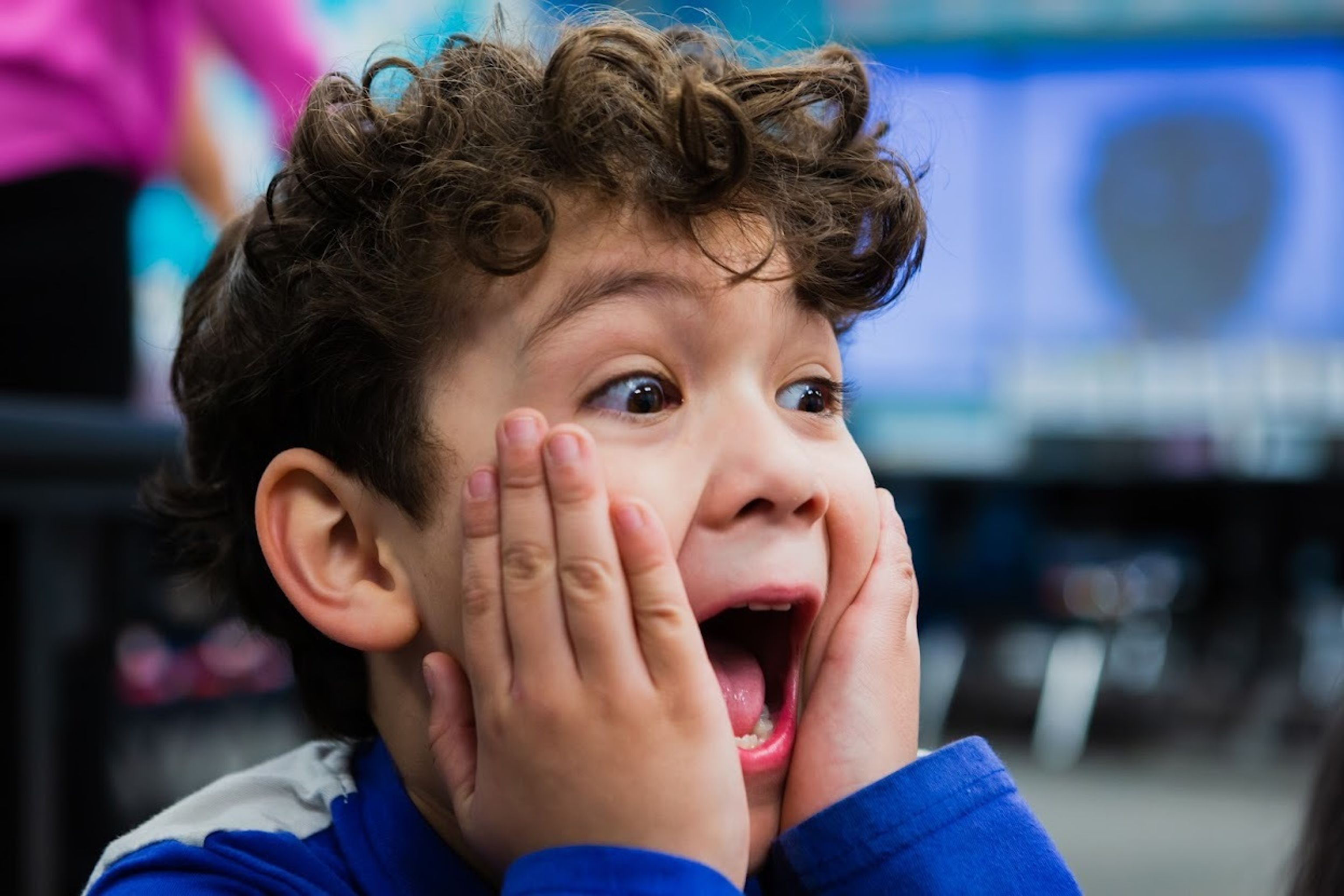 Boy holding hands to face in surprise