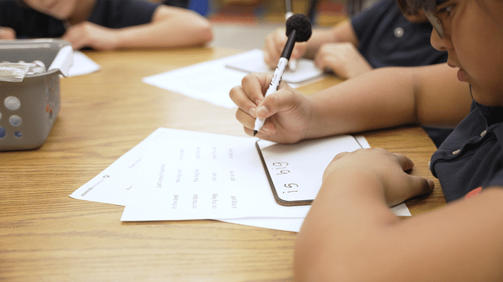 Student at desk practicing short vowels