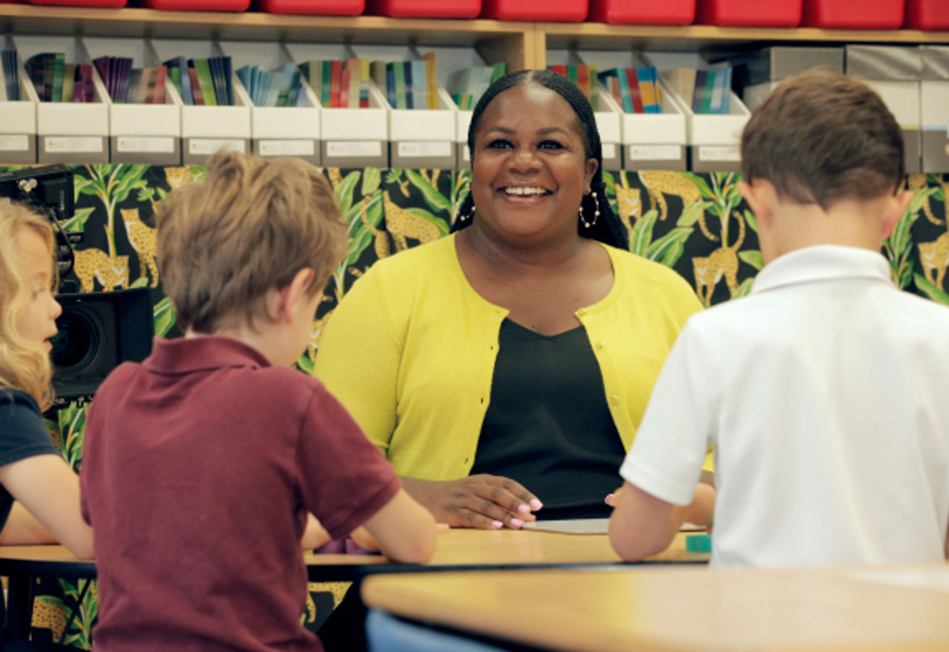 teacher smiling at two students