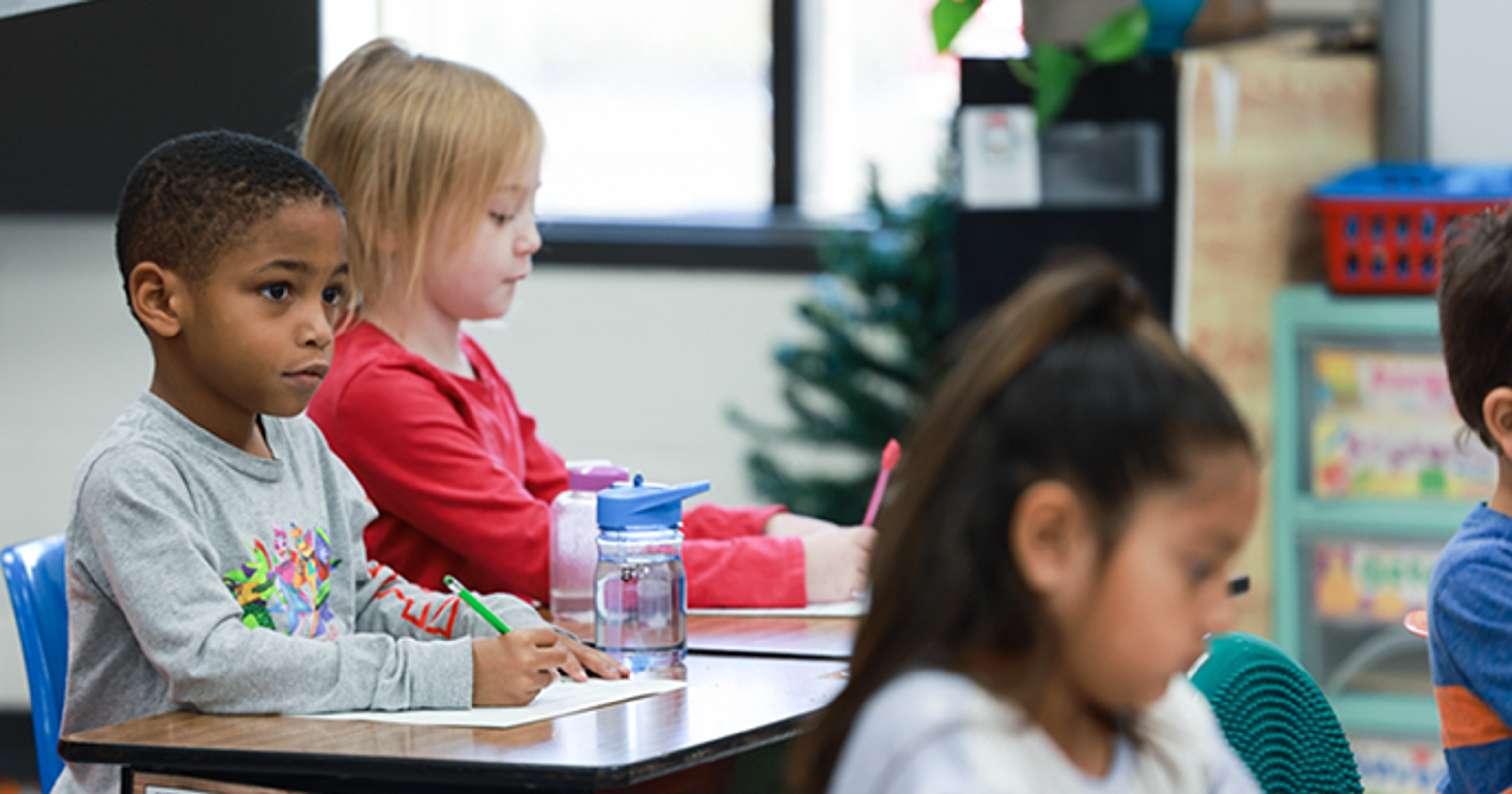 Elementary age students working at their desks