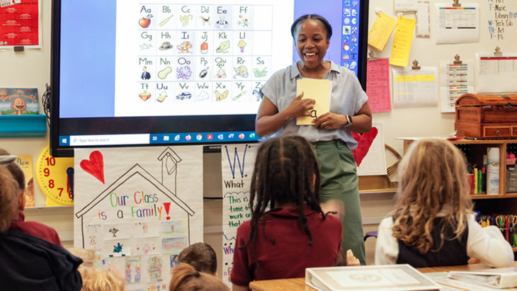 Teacher using letter flash cards with students