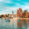 Tourists on a boats enjoying the day on a lake in Madrid Retiro Park, Spain