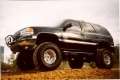 Picture of N-Fab Nerf Step 00-06 Chevy-GMC Tahoe-Yukon-Sonora SUV 4 Door - Gloss Black - W2W - 3in