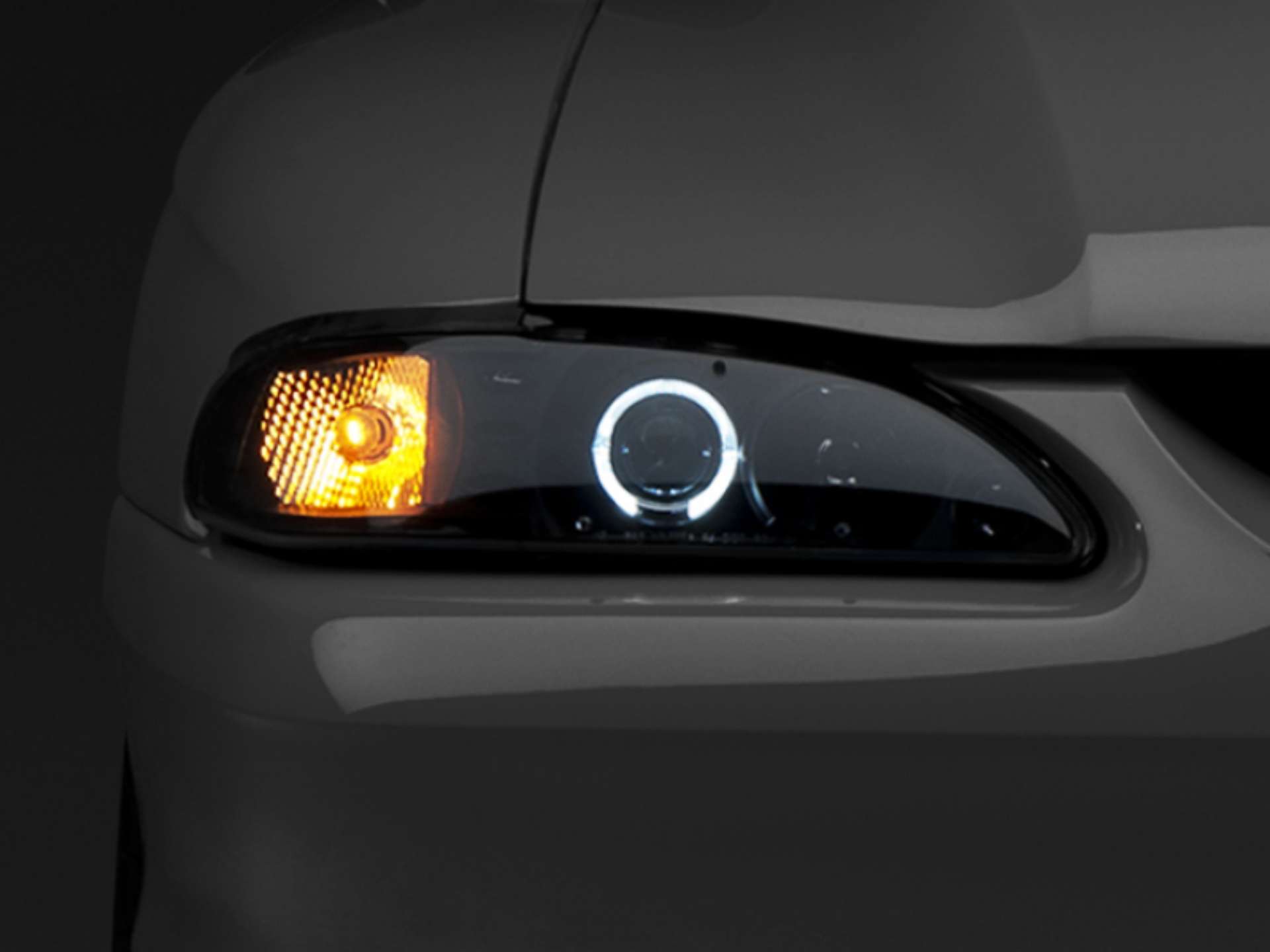 Picture of Raxiom 94-98 Ford Mustang LED Halo Projector Headlights- Black Housing Smoked Lens