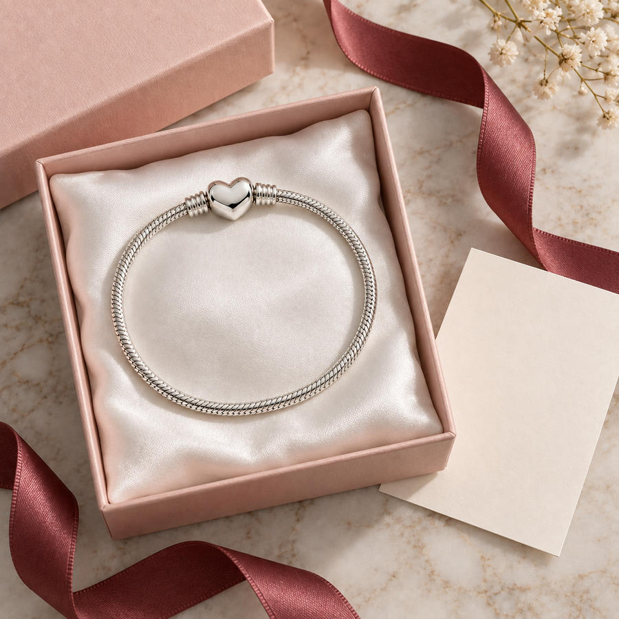 Bracelet resting on a satin cushion inside an open pink gift box