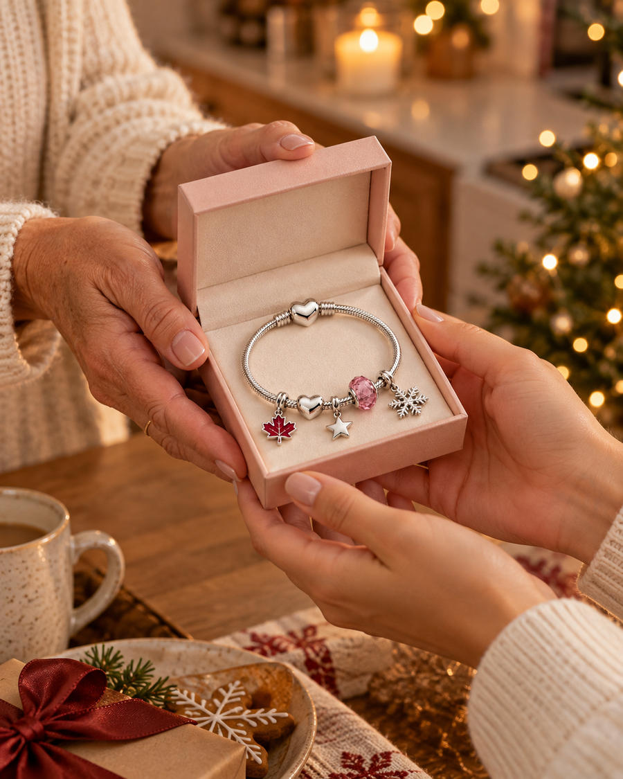 Open pink gift box with a charm bracelet and charms inside