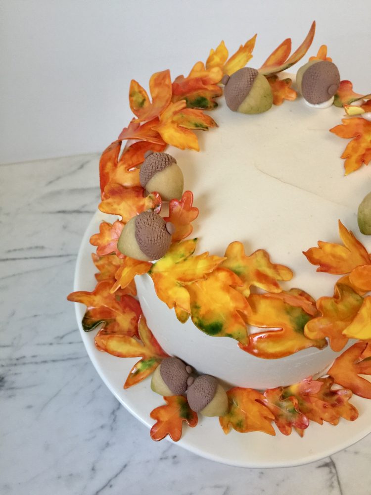 An wreath of gumpaste autumn leaves and marzipan acorns