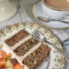 A slice of applesauce cake and cup of tea