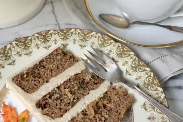 A slice of applesauce cake and cup of tea