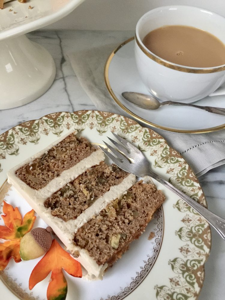 A slice of applesauce cake and cup of tea