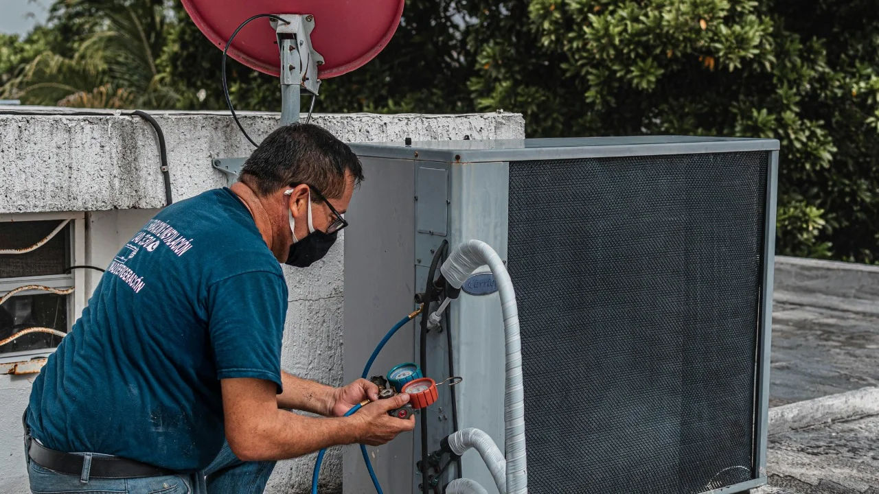 Two technicians repair a rooftop HVAC unit outside a Walmart store.