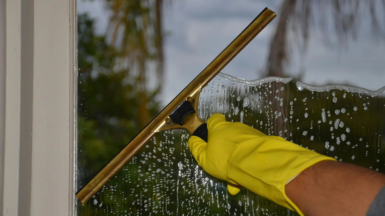 A street worker pressure washes stone stairs in a public park, ensuring cleanliness and safety.