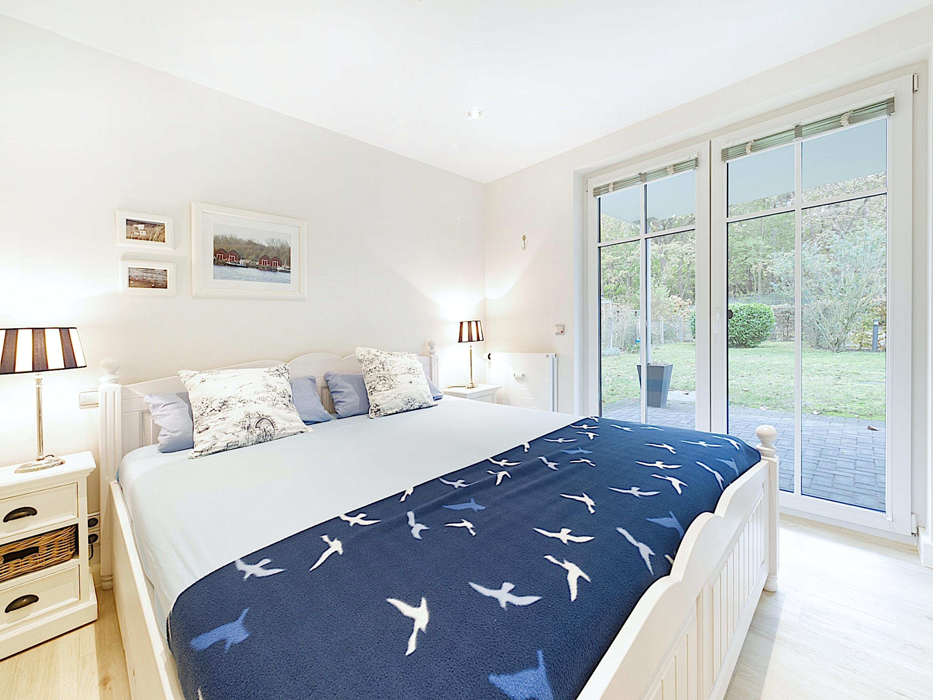Villa Belvedere, Ferienwohnung 08, großes Schlafzimmer mit einem Doppelbett und Zugang zur Südterrasse