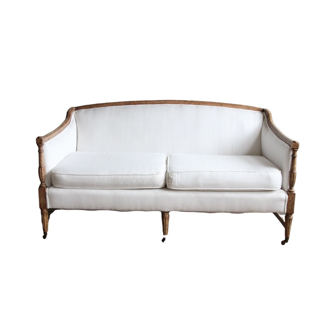 Bright white settee with carved wood accents