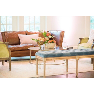 Leather sofa with colorful chairs and bench with gold coffee table 