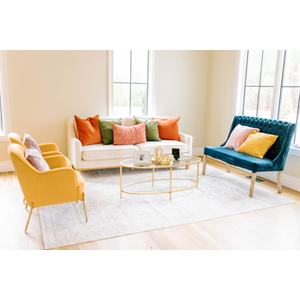 white sofa with yellow chairs and blue settee
