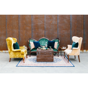 Vintage green sofa with vintage yellow and peach chair, with wood trunk