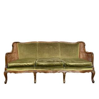 Green vintage sofa with cane wicker sides