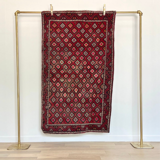 Deep red rug with diamond pattern