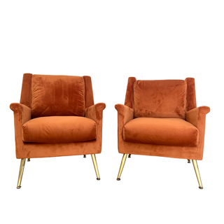 Orange velvet modern chairs with gold legs
