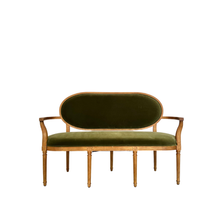 Green velvet sofa with wood detail