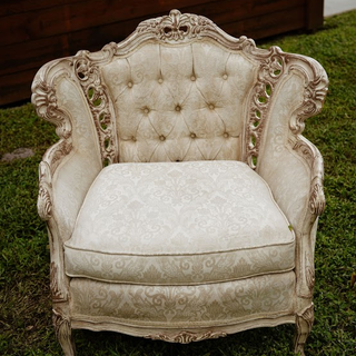 Ivory tuffed chair with gold trim has a matching couch 