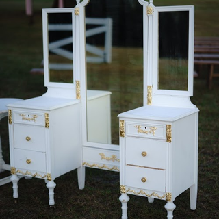 White vintage vanity with folding mirrors with gold accents