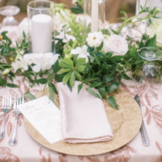 Floral gold charger with blush napkins at wedding reception.  Photo by Jenna Lindsey.